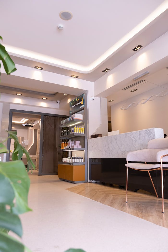 portfolio-03 Bright and elegant spa reception area showcasing modern interior design, marble desk, and comfortable seating.