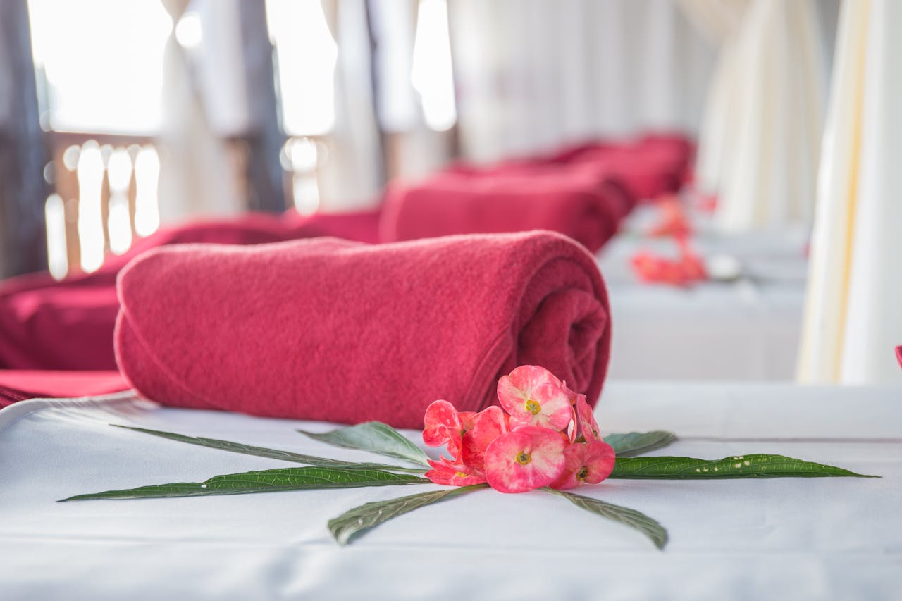 The Art of Drawing Readers In: Your attractive post title goes here Elegant spa interior featuring red rolled towels and vibrant flowers, perfect for relaxation.